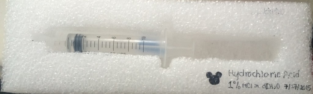 1-2% HCl solution in a syringe. 